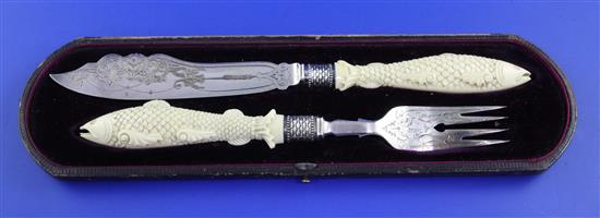 A cased small pair of Victorian carved ivory handled and silver fish servers, knife 9.75in.